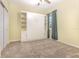 Bedroom featuring a Murphy bed with shelves, and a carpeted floor at 1006 Breggia Ct, Haines City, FL 33844