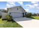 Single-story home showcasing the well-manicured lawn and front facade at 1006 Breggia Ct, Haines City, FL 33844