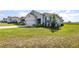 Well-manicured lawn leading to a gray single-Gathering home with attached garage at 1006 Breggia Ct, Haines City, FL 33844