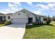 Charming one-story home with a well-maintained lawn and a two car garage at 1006 Breggia Ct, Haines City, FL 33844