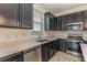 Bright and functional kitchen with modern stainless steel appliances and tile floors at 1006 Breggia Ct, Haines City, FL 33844