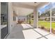 Covered and screened patio with a concrete floor, offering a view to the landscaped backyard at 1006 Breggia Ct, Haines City, FL 33844