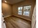 Cozy bedroom featuring hardwood floors and natural light from two windows, offering a comfortable living space at 1632 Haven Dr, Orlando, FL 32803