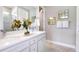 Bright bathroom with dual vanities, quartz countertops, and modern fixtures at 1671 Ruby Ln, Lake Alfred, FL 33850