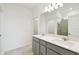 Bathroom featuring double sink, large mirror and a tiled shower, offering both functionality and a luxurious feel at 1671 Ruby Ln, Lake Alfred, FL 33850