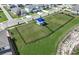 Aerial view of the community dog park that includes a shaded area for pet owners and dogs to socialize at 1671 Ruby Ln, Lake Alfred, FL 33850