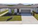 Charming single-story home with a well-manicured lawn and a two-car garage in a Gathering-friendly neighborhood at 1671 Ruby Ln, Lake Alfred, FL 33850