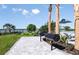 Outdoor grilling area featuring lush landscaping, stainless steel grills, and comfortable seating at 1671 Ruby Ln, Lake Alfred, FL 33850