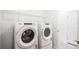 Convenient laundry room with modern washer and dryer, plus overhead shelving for organized storage solutions at 1671 Ruby Ln, Lake Alfred, FL 33850