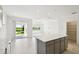 Bright living area with tile flooring, recessed lighting, and sliding glass doors opening to the outdoors at 1671 Ruby Ln, Lake Alfred, FL 33850