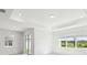 Spacious main bedroom featuring recessed lighting, tray ceiling, and bright windows offering scenic outdoor views at 1671 Ruby Ln, Lake Alfred, FL 33850