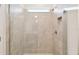 Modern tiled shower featuring glass doors and a built-in niche, offering a luxurious bathing experience at 1671 Ruby Ln, Lake Alfred, FL 33850