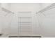 Spacious walk-in closet with metal shelving provides ample storage, keeping your wardrobe organized and accessible at 1671 Ruby Ln, Lake Alfred, FL 33850