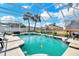 Inviting screened-in pool featuring clean water and a sun-drenched deck, perfect for leisurely swims and relaxation at 2410 Berkshire Ct, Kissimmee, FL 34746