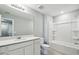Bright bathroom with single sink, shower-tub combo, and neutral color palette at 288 Woodsage Pl, Lake Alfred, FL 33850