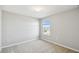 Neutral-toned bedroom with a window and carpeted floors at 288 Woodsage Pl, Lake Alfred, FL 33850