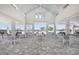 Spacious community center with tables and views of the beautiful pool and surrounding landscape at 288 Woodsage Pl, Lake Alfred, FL 33850