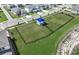 Aerial view of the fenced community dog park with shade structure and grassy area at 288 Woodsage Pl, Lake Alfred, FL 33850