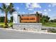 Community entrance sign reading 'Silverlake' with stone base, landscaping and palm trees at 288 Woodsage Pl, Lake Alfred, FL 33850