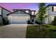 Charming two-story home with a well-manicured lawn and a two-car garage at 288 Woodsage Pl, Lake Alfred, FL 33850