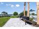 Outdoor grilling area with natural gas grills, palm trees, and views of the lake at 288 Woodsage Pl, Lake Alfred, FL 33850