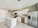 Modern kitchen features stainless steel appliances and white cabinetry at 288 Woodsage Pl, Lake Alfred, FL 33850
