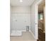 Laundry room featuring tile flooring, utility sink hookups, and a wall-mounted wire rack at 288 Woodsage Pl, Lake Alfred, FL 33850