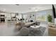 Bright open-concept living space features modern furnishings and tile flooring at 288 Woodsage Pl, Lake Alfred, FL 33850