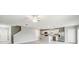 Bright open-concept living space features adjacent kitchen and white tile flooring at 288 Woodsage Pl, Lake Alfred, FL 33850