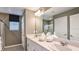 Bright bathroom with double vanity, framed mirror, and glass-enclosed shower at 342 Wayland Dr, Haines City, FL 33844