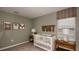 Adorable Bedroom with a cute crib, whimsical artwork, and warm lighting at 342 Wayland Dr, Haines City, FL 33844