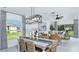 Bright dining room featuring elegant furnishings, a modern light fixture, and large windows at 346 Wayland Dr, Haines City, FL 33844