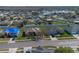 An aerial view of a neighborhood with a home and well-kept lawns at 3890 Wood Thrush Dr, Kissimmee, FL 34744