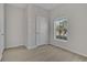 Neutral bedroom with wood look floors, one window letting in ample natural light and white trim at 3890 Wood Thrush Dr, Kissimmee, FL 34744