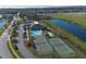 Aerial view of community amenities, including a pool, tennis courts, and clubhouse at 3890 Wood Thrush Dr, Kissimmee, FL 34744