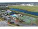 Aerial view of community amenities, including a pool, tennis courts, and clubhouse at 3890 Wood Thrush Dr, Kissimmee, FL 34744