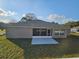 Backyard view of home, showcasing a screened-in porch and a spacious lawn at 1260 Buckeye Ne Rd, Winter Haven, FL 33881