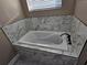 Large soaking tub with marble tile surround and modern fixtures at 1260 Buckeye Ne Rd, Winter Haven, FL 33881