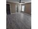 Neutral bedroom with wood-look flooring, an overhead fan, and an ensuite bathroom at 1260 Buckeye Ne Rd, Winter Haven, FL 33881