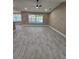 Spacious living room with tile floors, a ceiling fan, and lots of natural light at 1260 Buckeye Ne Rd, Winter Haven, FL 33881