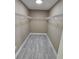 Spacious walk-in closet with neutral paint, wood-look floors, and a white shelving unit at 1260 Buckeye Ne Rd, Winter Haven, FL 33881