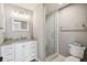 Bathroom features a modern vanity with granite countertops and a glass-enclosed shower at 1353 Lajolla Cir, The Villages, FL 32159
