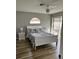 Bright bedroom with a large bed, light hardwood floors, and sliding glass doors to the outside at 1353 Lajolla Cir, The Villages, FL 32159