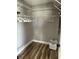 Well-organized walk-in closet with ample storage space and wood floors at 1353 Lajolla Cir, The Villages, FL 32159