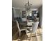 Cozy dining area with a round table, stylish light fixture, and seamless flow into the living room at 1353 Lajolla Cir, The Villages, FL 32159