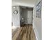 Hallway with luxury vinyl plank floors, neutral paint, and coastal-inspired art at 1353 Lajolla Cir, The Villages, FL 32159