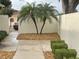 Yard featuring decorative stone, paver walkway and small palm trees at 1353 Lajolla Cir, The Villages, FL 32159