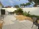 Well-manicured backyard with mature landscaping, privacy fence, and patio is ready for outdoor enjoyment at 1353 Lajolla Cir, The Villages, FL 32159