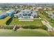 Aerial view of the estate showcasing manicured lawn, dock and stunning blue pool at 472 Desoto Dr, New Smyrna Beach, FL 32169