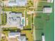 Aerial view of the home's recreational amenities: bocce court, putting green, chipping green, docks, and boat lifts at 472 Desoto Dr, New Smyrna Beach, FL 32169